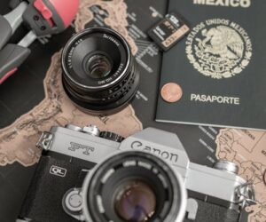 Camera, passport and map on table — planning a Madagascar trip budget