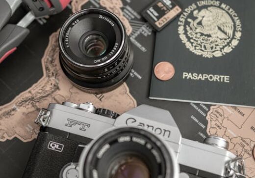 Camera, passport and map on table — planning a Madagascar trip budget