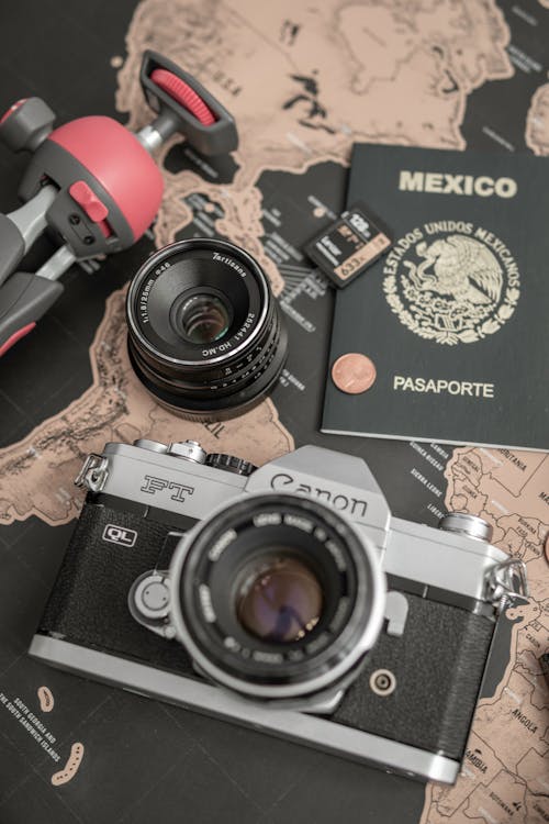 Camera, passport and map on table — planning a Madagascar trip budget