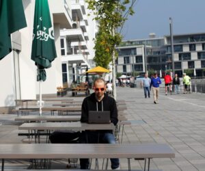Person working on laptop while traveling