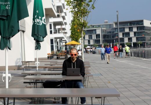 Person working on laptop while traveling
