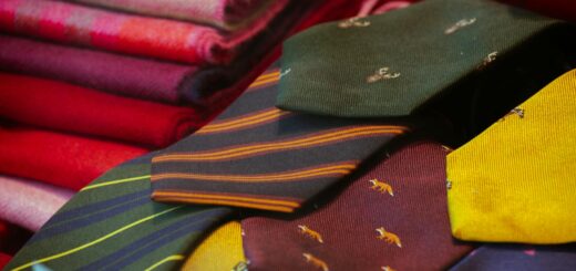 Colorful silk lamba textiles — A vibrant display of patterned silk ties and colorful wool fabrics, perfect for men's fashion and textile lovers.